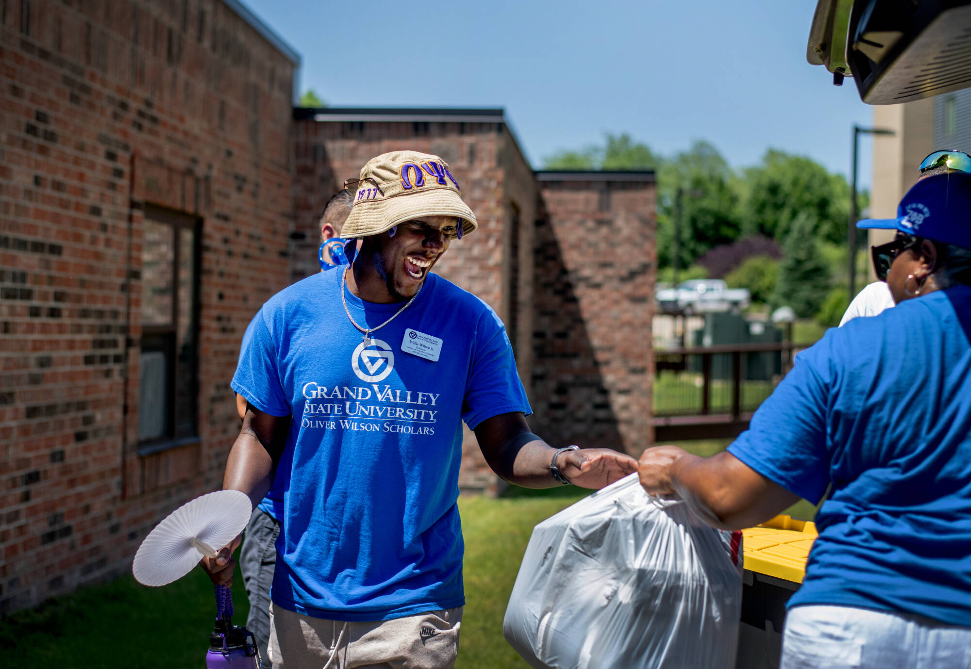 Willie Wilson helps students move into their housing for the OWS summer bridge program.